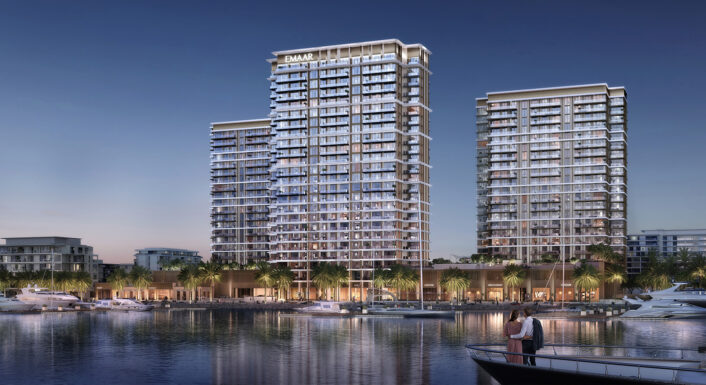 Emaar towers at Rashid Yachts & Marina lit over the water at dusk